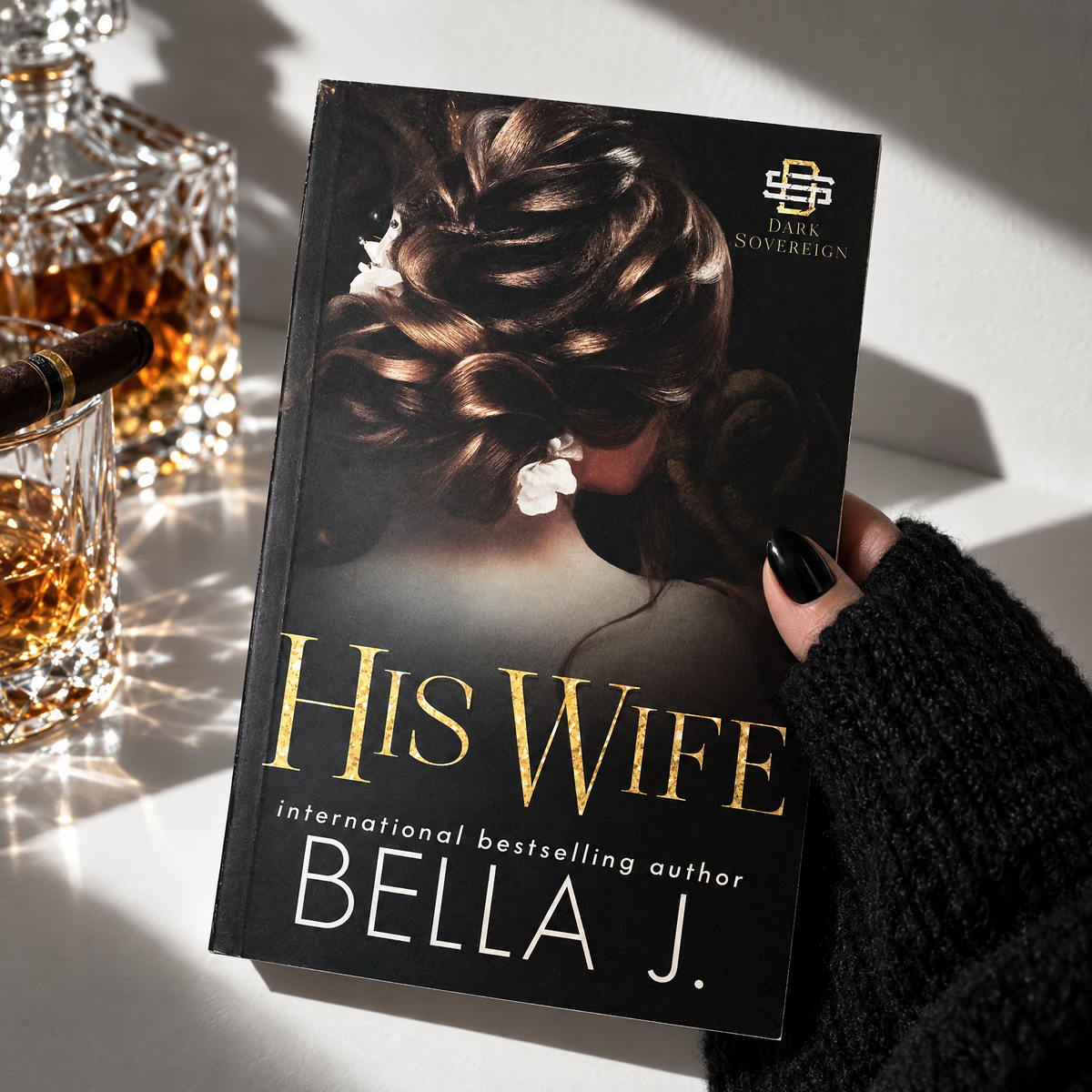 Hand holding a signed paperback of His Wife by Bella J., model cover, Alexius trilogy book 2