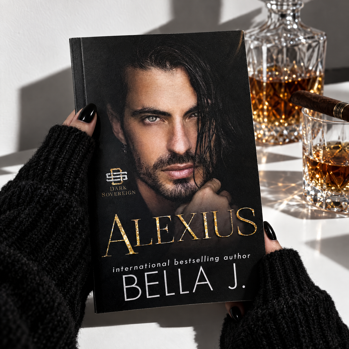 Hand holding a signed paperback of Alexius by Bella J., the bestselling Dark Sovereign mafia romance